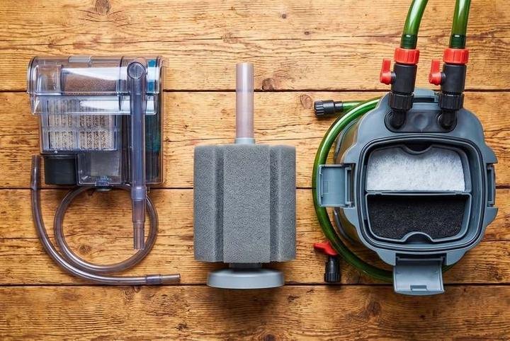 Three aquarium filter types side by side: hang-on-back, sponge, and canister